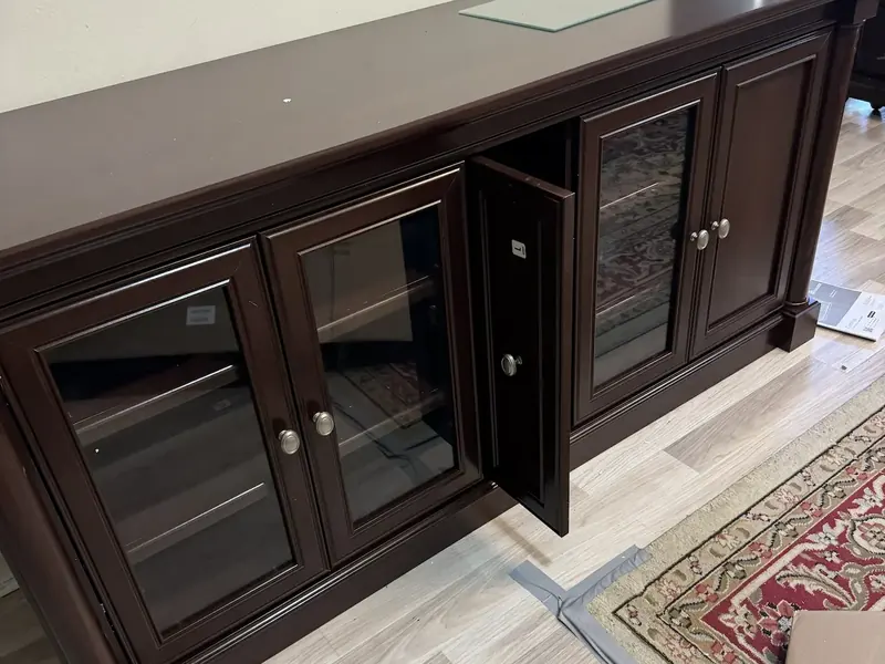 Dark wood glass-front sideboard assembled with its doors hung and the reveals even
