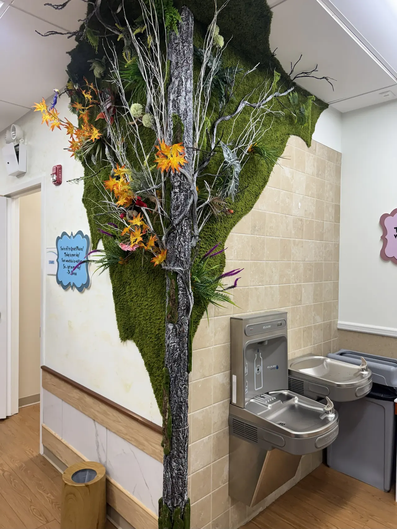 Large feature wall art installed securely around a column with clean edges and balanced composition — NYC commercial interior