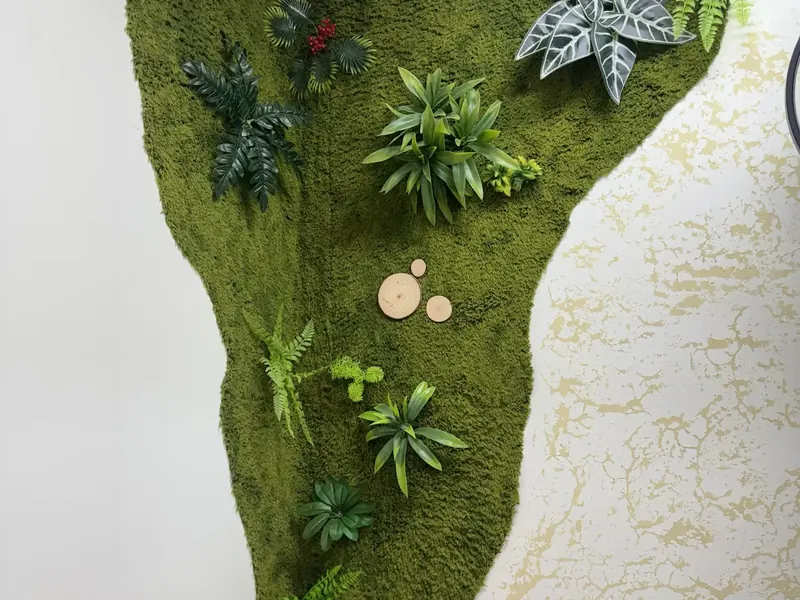 Preserved moss panel with foliage installed against a textured white wall in a curved profile