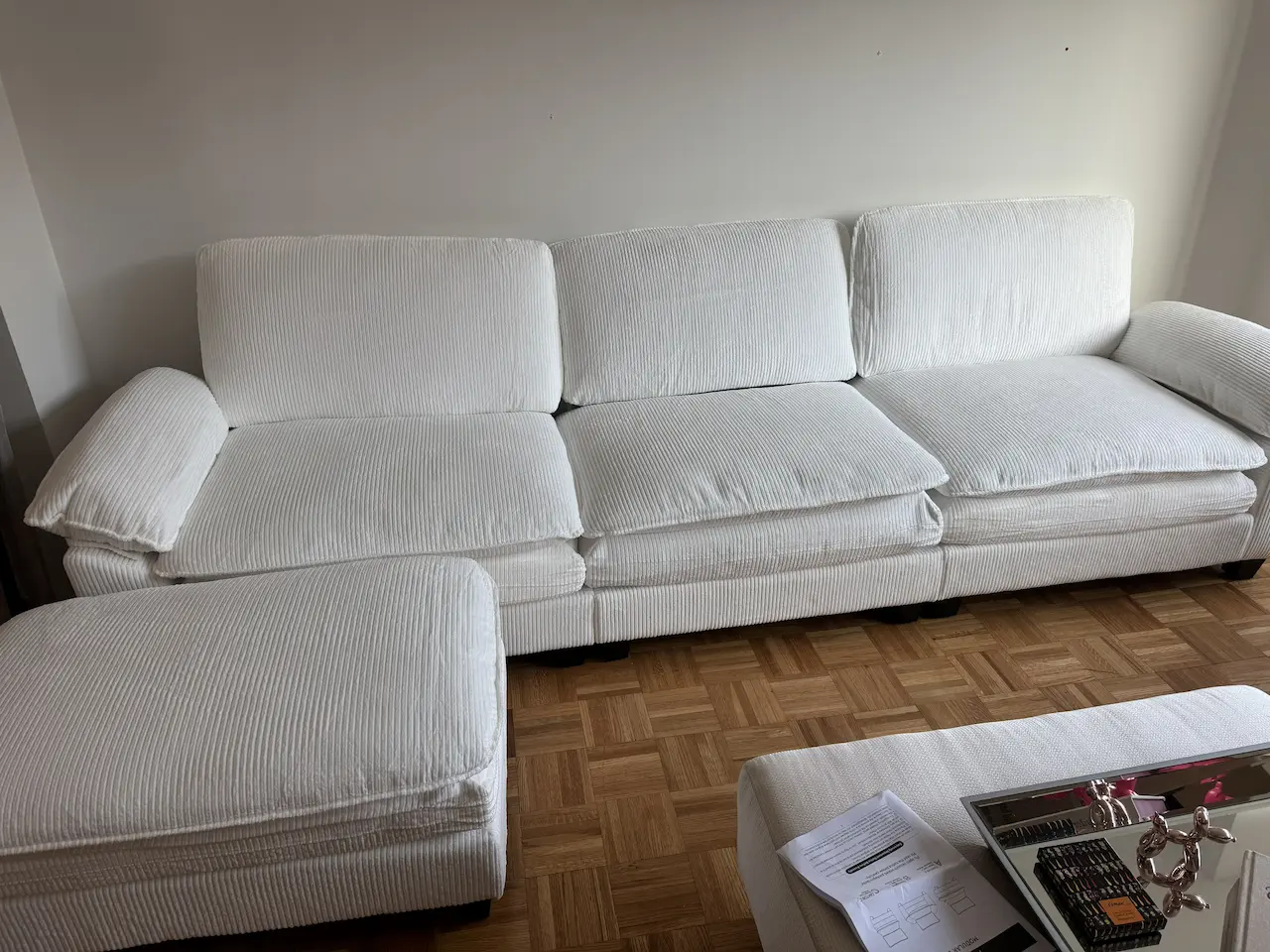Large white sofa assembled with leveled feet and even cushion spacing — Brooklyn interior