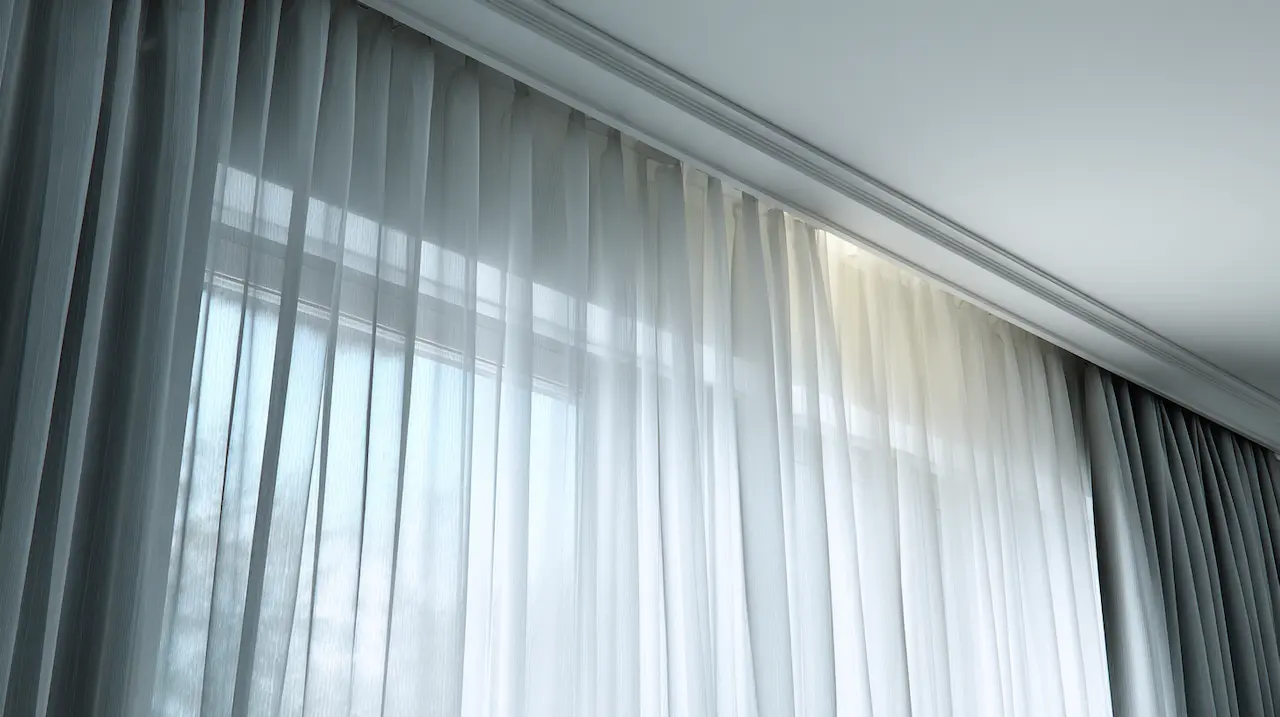 Dual-layer installation with sheer and blackout curtains on double track — clean terminations in Brooklyn apartment